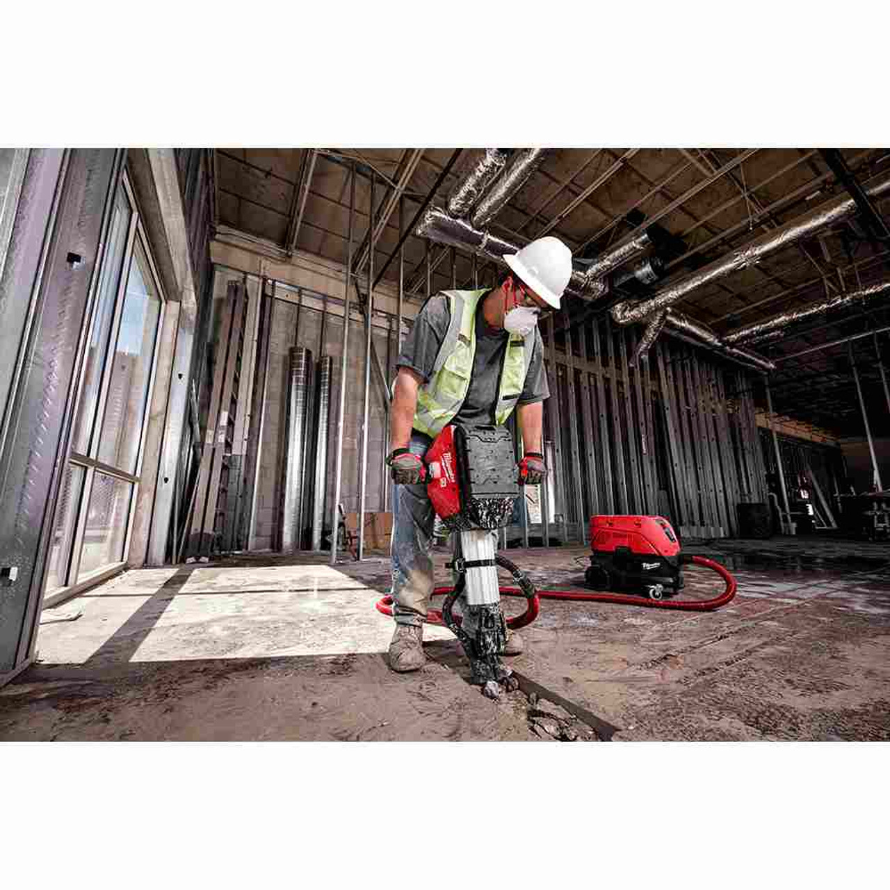 Milwaukee MXF368-1XC MX FUEL Cordless Demolition Breaker Kit showing in use breaking up a trench in concrete