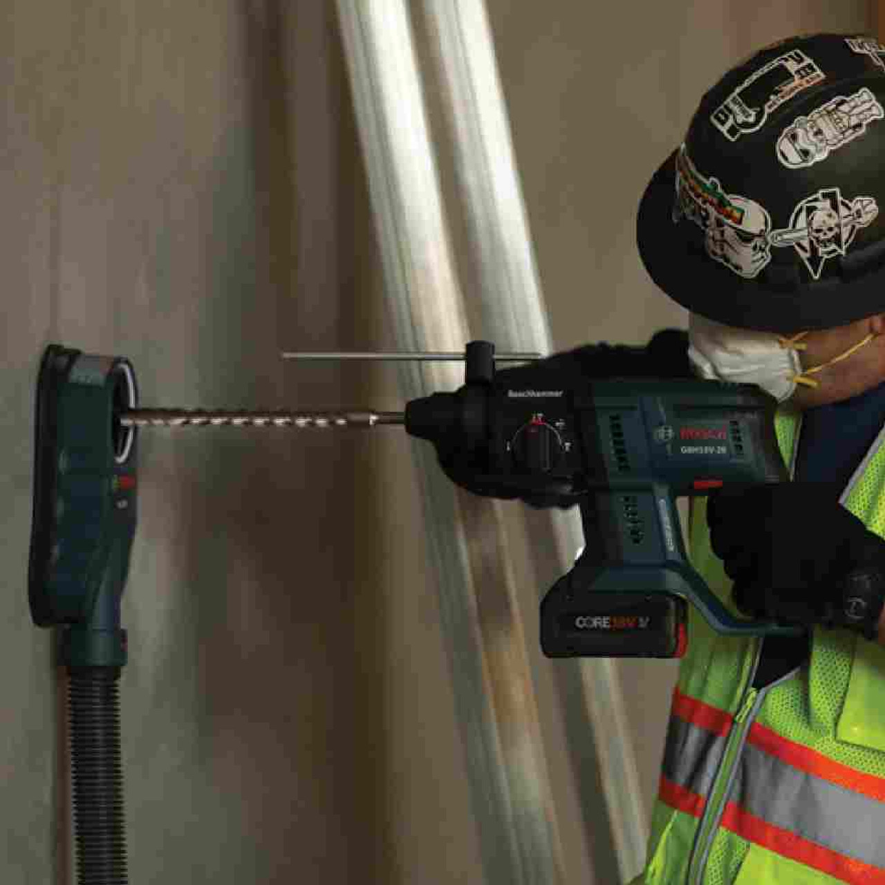 Bosch HDC200 Universal Dust Collection Attachment  showing in use drilling hole into concrete wall with drill (Sold Separately) Bosch HDC200 Universal Dust Collection Attachment  showing in use drilling hole into concrete wall with drill (Sold Separately)