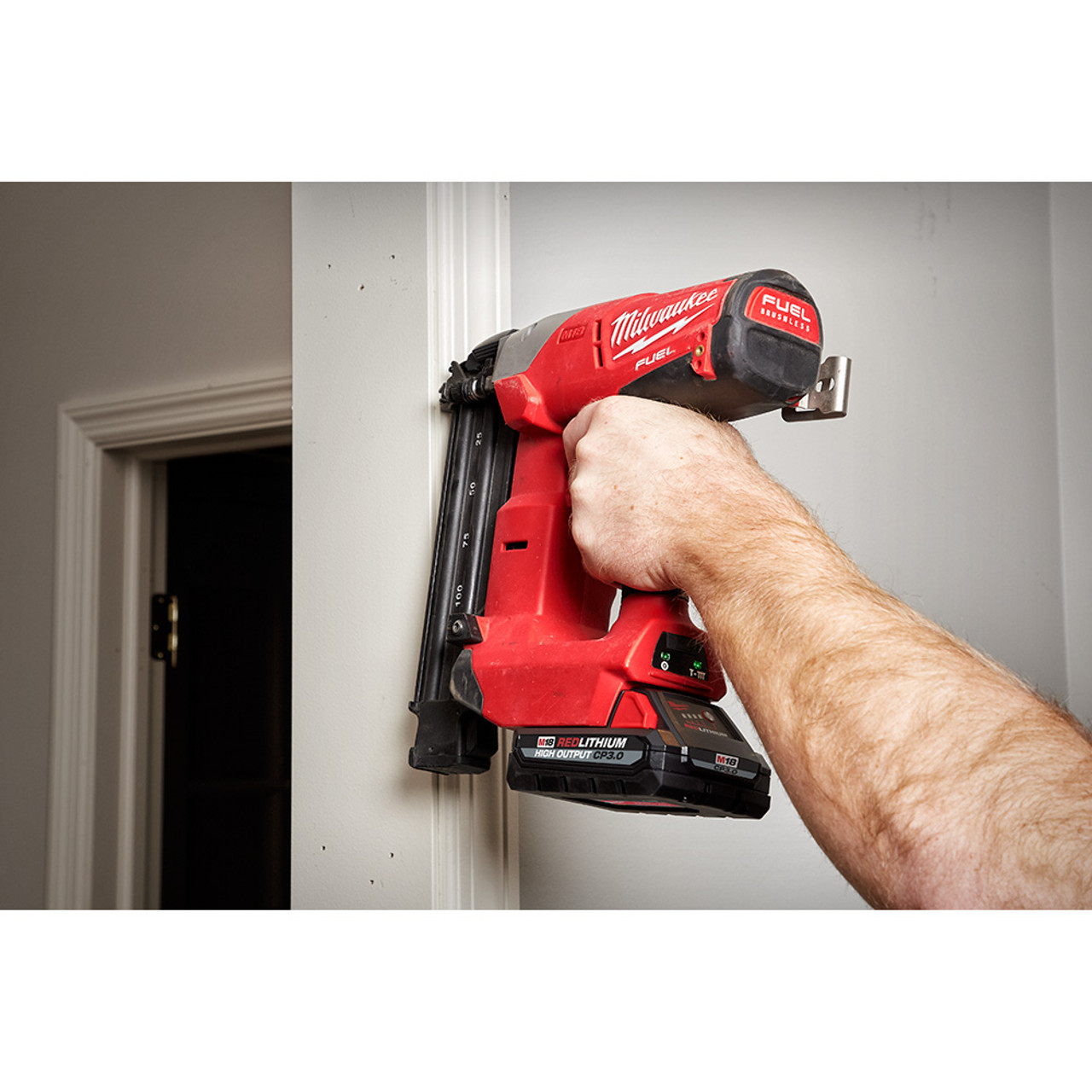 Milwaukee 48-11-1835 M18 REDLITHIUM HIGH OUTPUT CP3.0 Battery showing battery in use on nailer to attach door casing