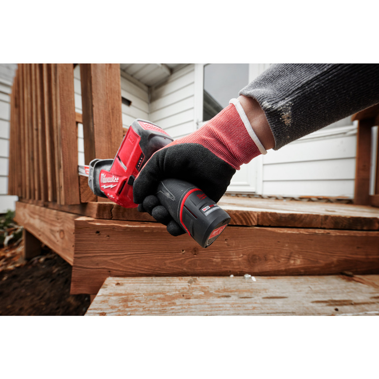 Milwaukee 48-11-2425 M12 REDLITHIUM HIGH OUTPUT CP2.5 Battery showing battery in use on a hackzall cutting wood spindles