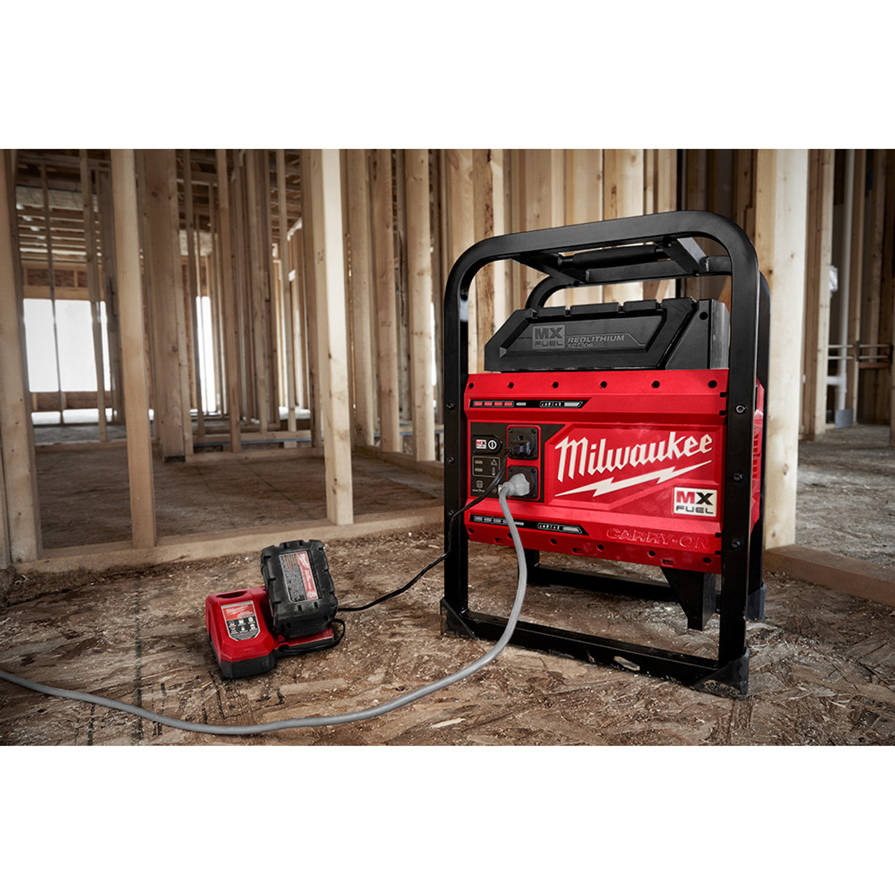 Milwaukee MXF002-2XC MX FUEL CARRY-ON Cordless 3600W/1800W Power Supply Generator Kit showing in use with a M18 charger