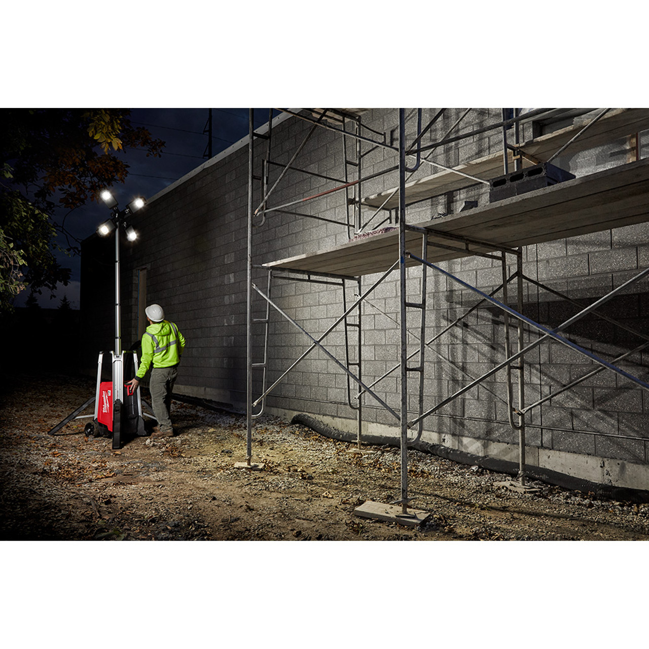 Milwaukee MXF041-1XC MX FUEL ROCKET Cordless 10 foot Tower Light / Charger Kit showing in use light up exterior work site at night