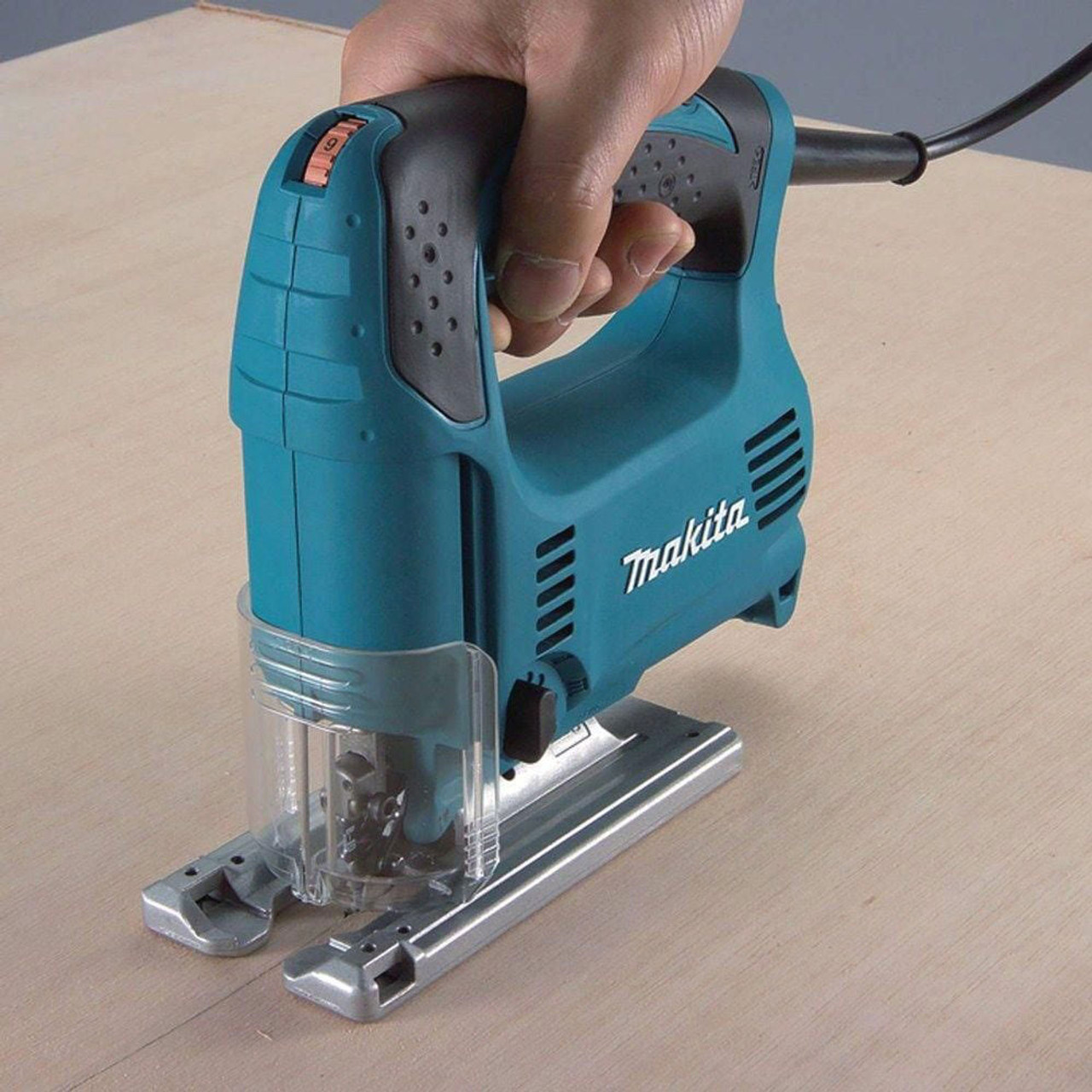 Makita 4329K 3.9 Amp Variable Speed Orbital Jig Saw with D-Handle showing in use cutting flat stock Makita 4329K 3.9 Amp Variable Speed Orbital Jig Saw with D-Handle showing in use cutting flat stock