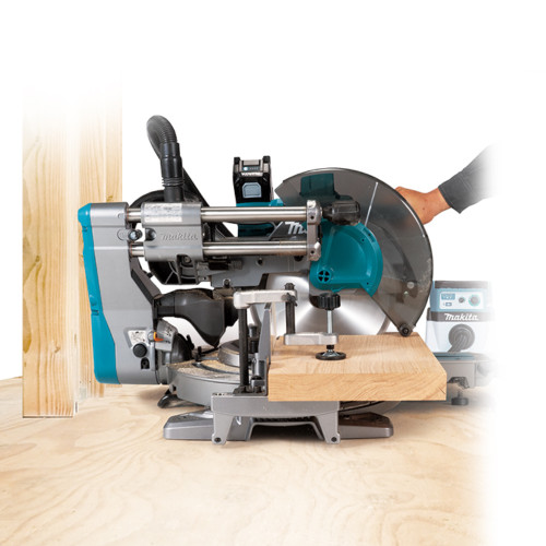 Makita LS003GM102 40V MAX XGT Cordless Brushless 12 inch Mitre Saw Kit showing saw in use cutting through dimensional lumber