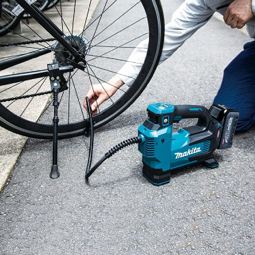Makita MP001GZ 40V MAX XGT Cordless Inflator (Tool Only) showing in use inflating a bicycle tire