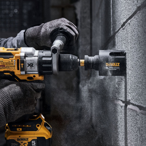 DeWalt DAH42916 ELITE SERIES 2-9/16 Inch Multi-Material Hole Saw showing in use drilling into cinder block wall
