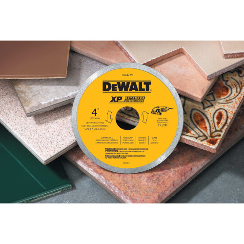 DeWalt DW4729 XP 4-1/2 inch Continuous Rim Tile Blade showing blade resting on a jobsite leaning against block