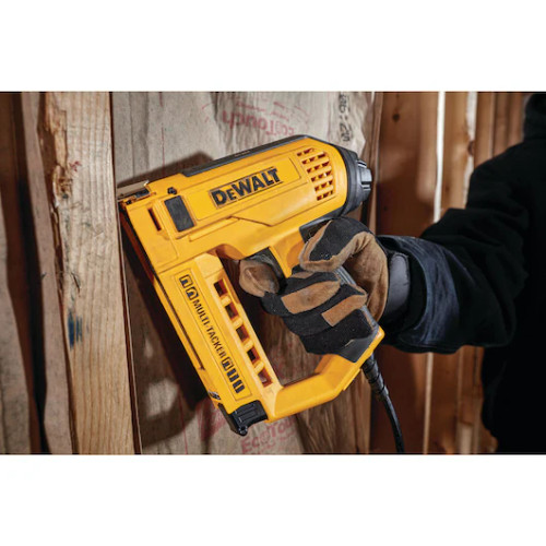 DeWalt DWHT75021 Heavy-Duty Electric 5-in-1 Multi-Tacker showing in use taking paper to wood studs