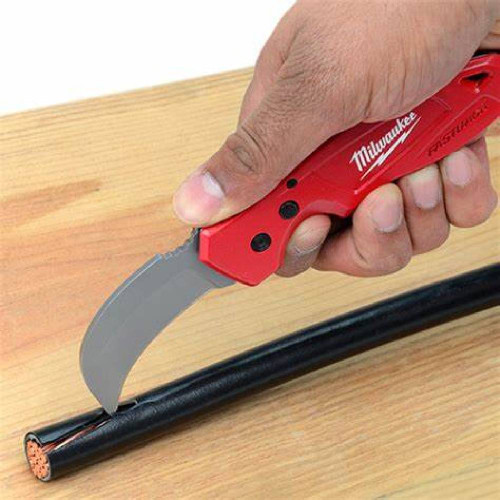 Milwaukee 48-22-1985 FASTBACK Hawkbill Folding Knife showing in use cutting casing of large cable