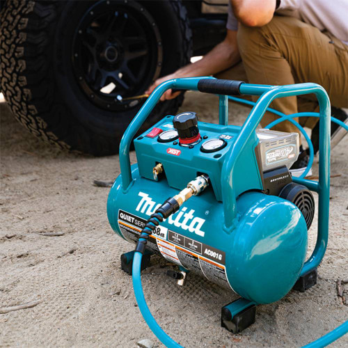 Makita AC001GZ 40V XGT 2 Gallon Air Compressor (Tool Only) showing in use inflating a tire (Battery and attachments are sold separately)
