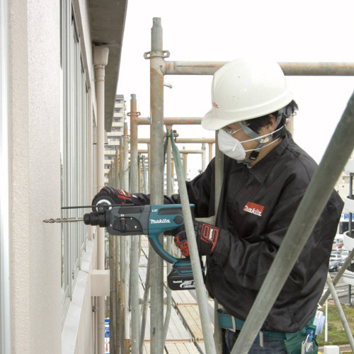 Makita DHR202Z 18V LXT SDS-PLUS 15/16in Rotary Hammer (Tool Only) showing in use drilling into concrete wall (Battery & Bit sold separately)