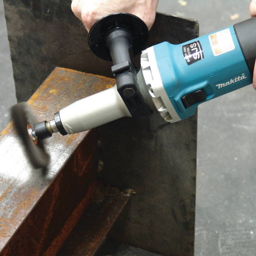 Makita GD0800C 6.6 Amp Die Grinder showing in use removing rust from metal with a wire wheel (Side Handle and attachment sold separately)