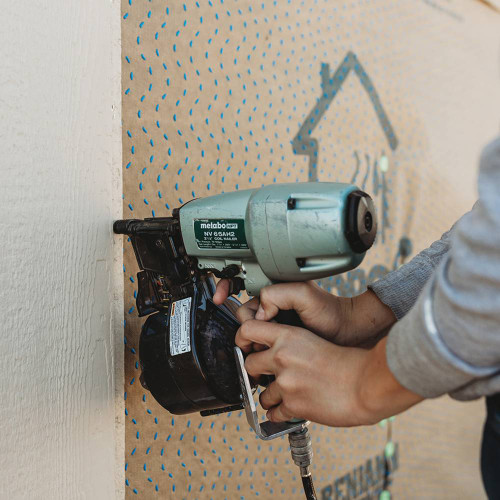 Metabo HPT KNV65AH2M 2-Tool 2-12in Coil Siding Nailer & 18V MultiVolt Triple Hammer Bolt Impact Driver Kit showing in use nailing up siding