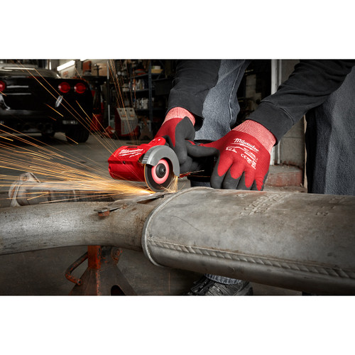 Milwaukee 2522-20 M12 FUEL Brushless 3-inch Compact Cut-Off Saw cutting an exhaust pipe (battery sold separately)
