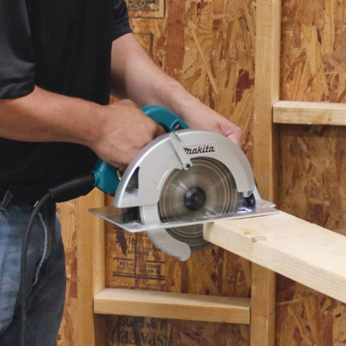 Makita 5007FA 15 Amp 7-1/4-inch Circular Saw with Brake showing in use cutting down a wooden stud