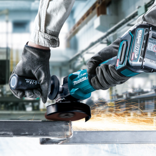 Makita GA005GZ 40V XGT Cordless Brushless 5 inch Angle Grinder - Slide Switch (Tool Only) showing in use grinding off a finished weld on steal square tubing