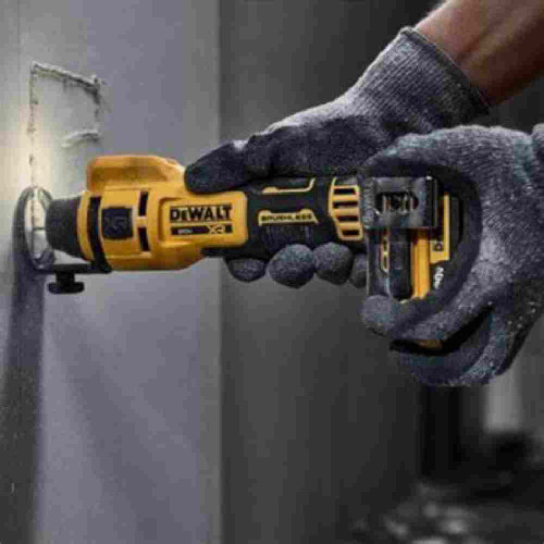 DeWalt DCE555B 20V MAX XR Cordless Brushless Drywall Cut-Out Tool (Tool Only) showing in use cutting a electrical switch box out of drywall panel