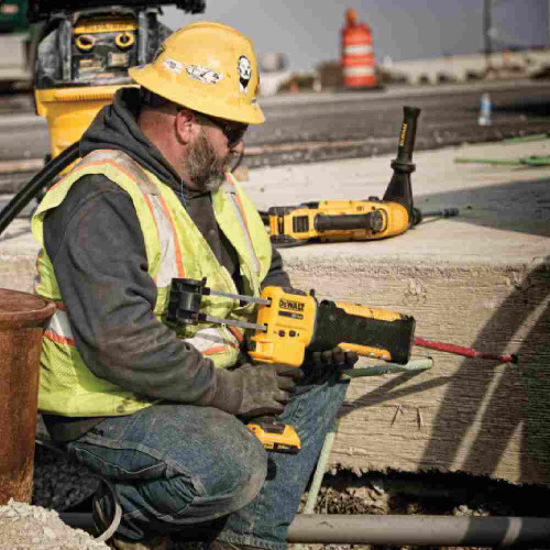 DeWalt DCE595B 20V MAX Cordless Brushless 10oz Adhesive Gun (Tool Only) showing in use gluing rebar into concrete slab