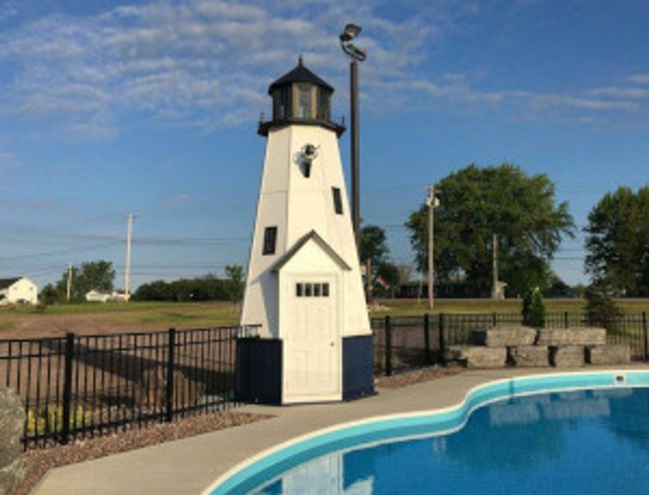 Custom lighthouse serves as a pool house.