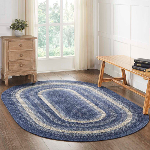 VHC Brands Great Falls oval braided rug in blue & cream, pictured on living room floor.