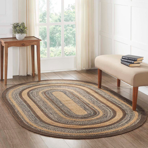 VHC Brands Espresso oval jute braided rug, 60" x 96", pictured on living room floor.
