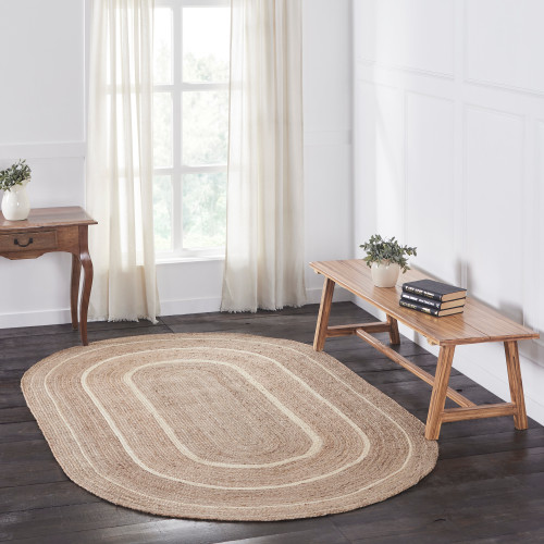 VHC Brands oval braided jute area rug, natural & cream, 60" x 96", pictured in a living room.