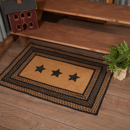 VHC Brands Farmhouse Stencil Stars rectangle braided jute rug in black & tan, 24" x 36", pictured at base of stairs.