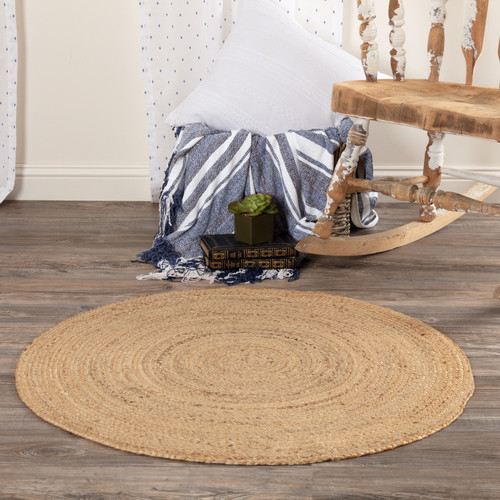 VHC Brands Harlow jute braided rug, 3 foot round, natural, pictured on sitting room floor.