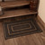 VHC Brands black & tan braided rug, 24"x36", pictured at foot of stairs.
