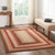 VHC Brands Ginger Spice rectangle, jute, braided rug, 60" x 96", pictured on living room floor.