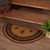 VHC Brands Heritage Farms Star & Pip, braided jute half circle rug, black, tan, burgundy, pictured at foot of staircase.