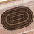 VHC Brands oval braided jute rug, black & tan, 20" x 30", pictured at entrance door.