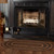 VHC Brands oval braided jute rug, black and tan, 27" x 48", pictured in front of fireplace.