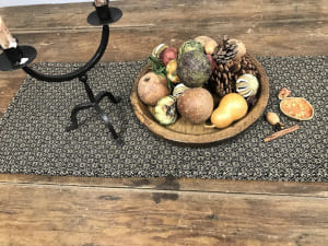 Primitive table runner in black on wooden table