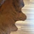Rich brown cowhide rug with natural patterns on wooden flooring
