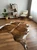 Brown and white cowhide rug on wooden floor in cozy living room
