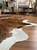 Brown and white cowhide rug on hardwood floor, natural animal skin texture for home decor