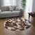 Round cowhide rug with brown and white pattern in modern living room