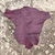 burgundy red kangroo hide on a textured stone surface