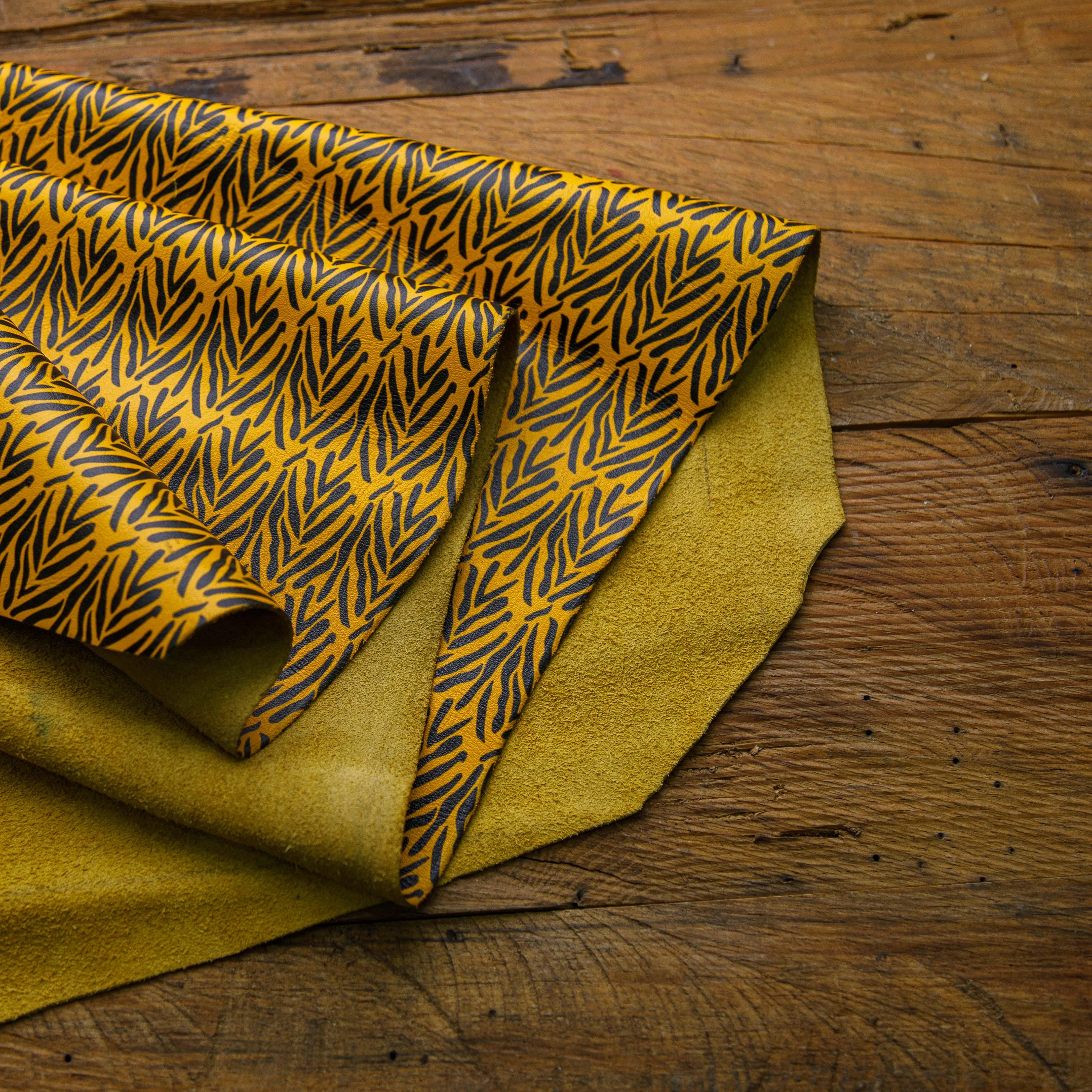 Black leaves pattern on yellow leather – printed leather hide for bags and fashion accessories