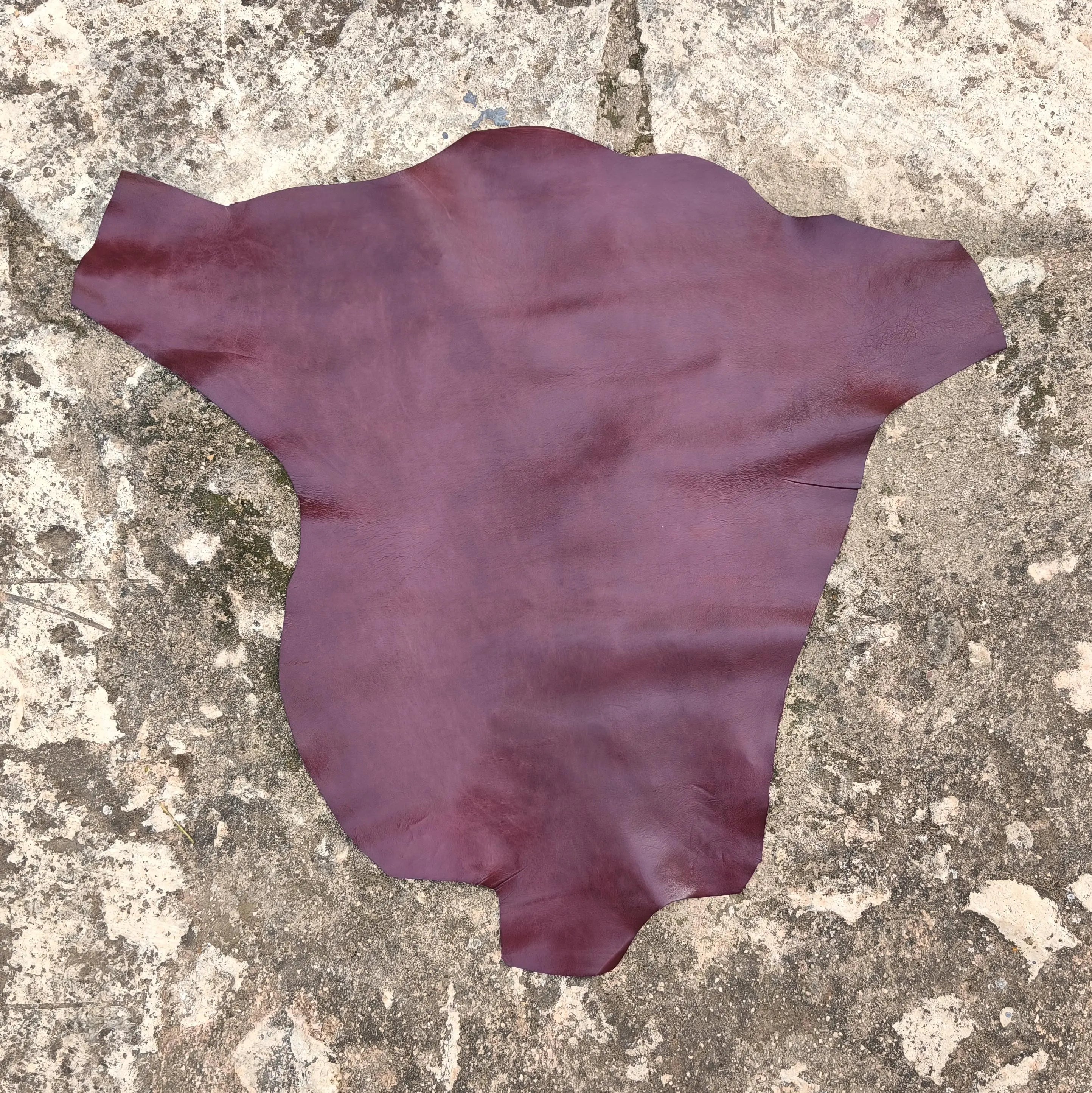 burgundy red kangroo hide on a textured stone surface