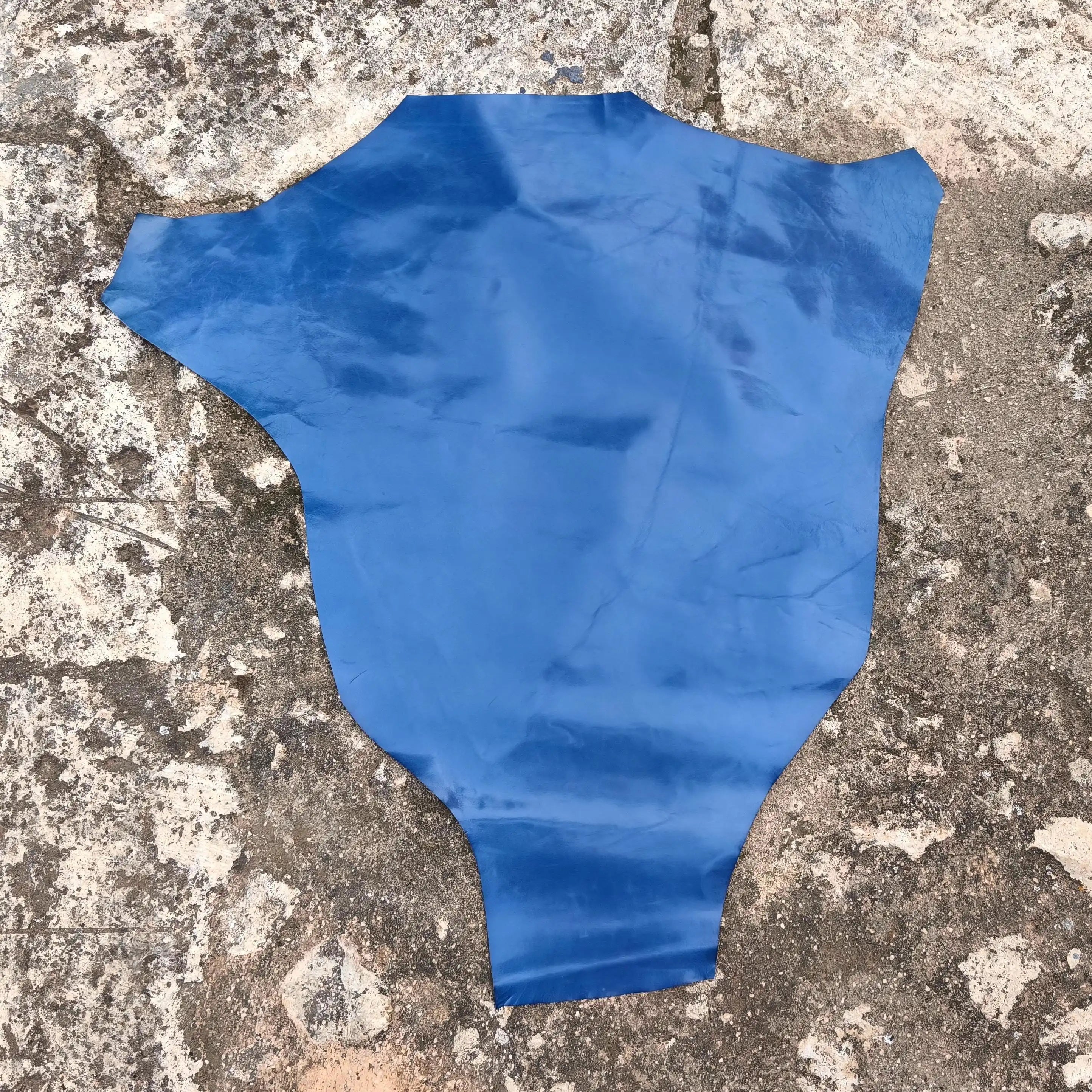 Blue kangaroo hide on a textured concrete surface