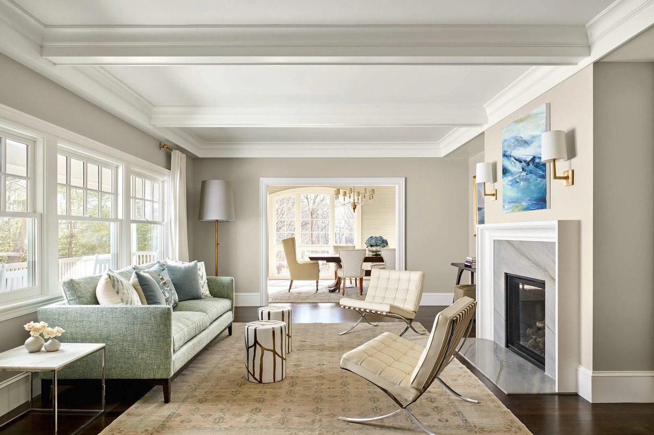 Living room with crown moulding looking through to a dining room