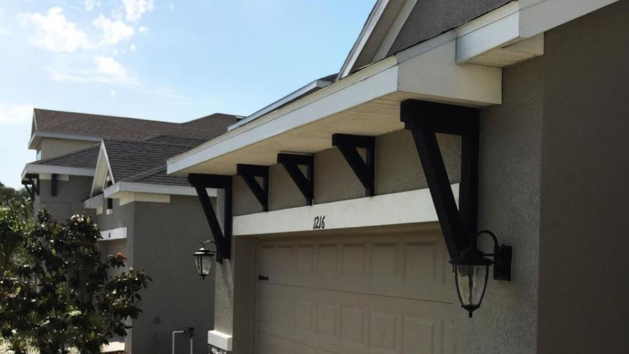 Black brackets holding a garage overhang