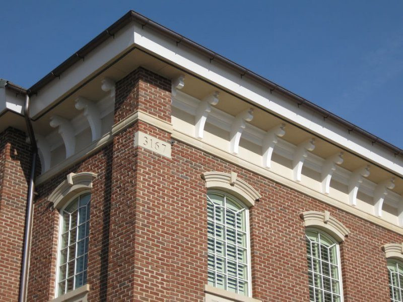 A row of corbels along a brick building