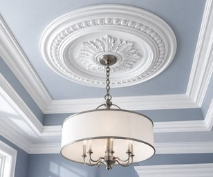 Ornate white ceiling medallion above a brass pendant lantern