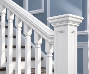 White porch handrail with turned balusters and a newel post