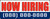 Now Hiring Banner Sign White Background with Red Lettering Personalized Phone Number Option Blue Background with White Lettering