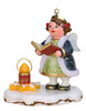 angel figurine holding hymnal with candle on snowy star base