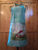 Handmade turquoise apron with a large adventure‑themed gnome pocket and matching turquoise head loop and waist ties